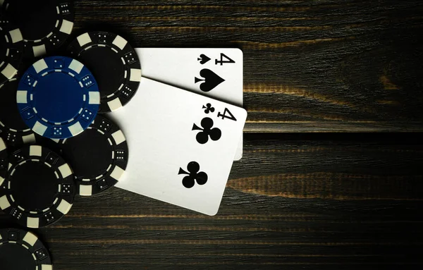 A popular poker game with a winning combination of one pair. Two cards with chips on a vintage table in a poker club.