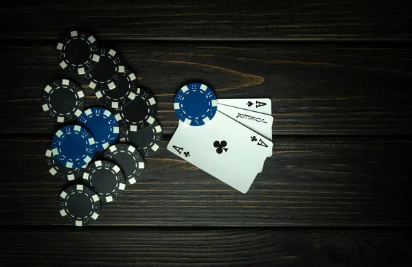A poker game with a winning combination of three aces. Cards with chips on a vintage table in a poker club. Free space for advertising.