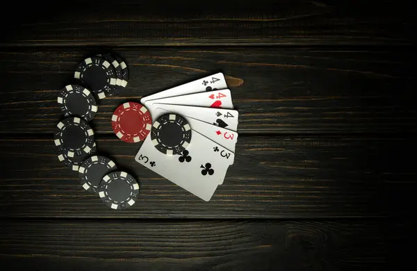 A very popular poker game with a winning combination of full house or full boat. Cards with chips from winnings on a vintage table in a poker club.