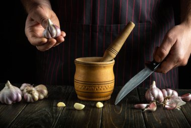 Tat ve aroma için besin eklemeden önce havanda Chasnok 'un elle işlenmesi. Mutfak masasında çalışma ortamı