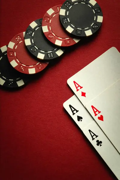stock image Card winning with a combination of aces four of a kind or quads and chips on a red table in a casino. Place for advertising.