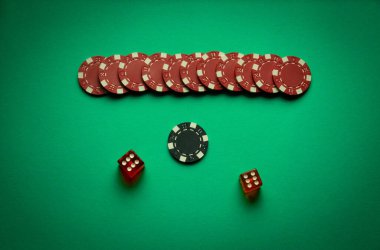 Dice and winning chips on a green table in a poker club. A successful combination of two sixes in a dice. Concept of winning in a casino. clipart