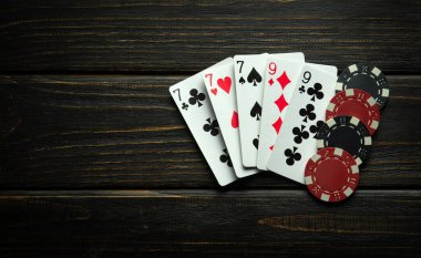 Combination of full house or full boat playing cards and winning chips on a black vintage table. Low key concept of winning combination in poker club or casino. clipart