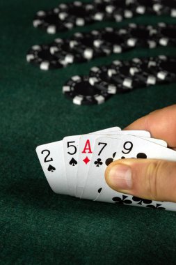 Bir kumarbazın elinde yüksek kart kombinasyonları olan poker kartları. Yeşil masadaki bir poker kulübünde kazanma kombinasyonu. Kumarda şans ya da servet fikri.