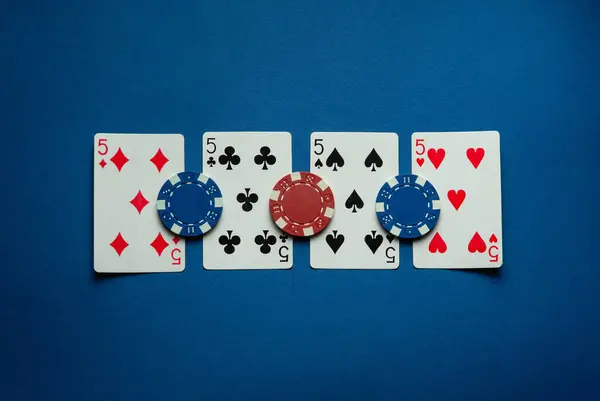 stock image Four kind or quads of playing cards in poker give a very rich win of chips. The concept of winning in a card game. A lucky win in a club or casino.