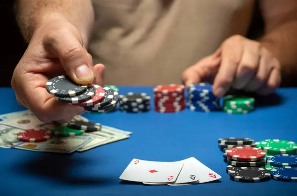 stock image The player places a bet with playing chips on the winning combination of cards three aces in the club. A successful poker game with a win.