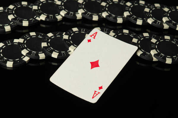 Casino winning symbol ace of diamonds. Playing card with chips on a black table in a poker club. Prediction of a good win.