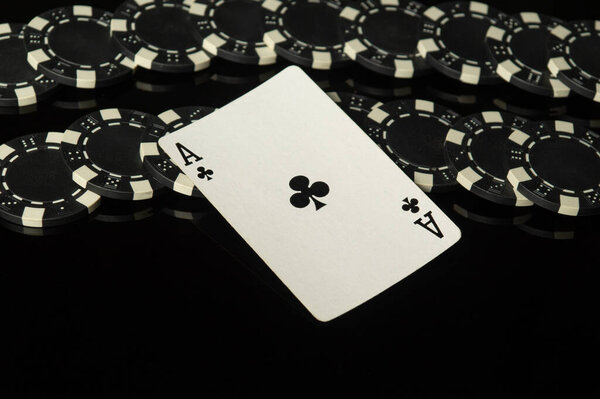 Casino winning symbol ace of clubs. Playing card with black chips on the table in the men club. Prediction of a successful victory.