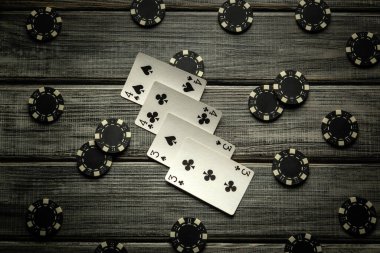 A thrilling poker game unfolds on a rustic wooden table, featuring a two pairs win combination and various poker chips scattered around, creating a tense atmosphere for the players. clipart