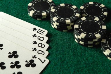 Yeşil bir keçeli masa üzerine serilmiş poker fişleri ve iskambil kağıtları koleksiyonu arkadaşlarla heyecanlı bir oyun akşamını akla getiriyor. Kartlarda floş var, heyecan ve gerilim ekliyor..