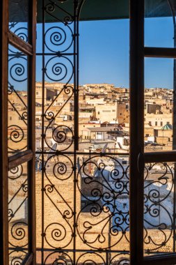 Fez medina seen through riad's window with decorative grate, Morocco, North Africa
