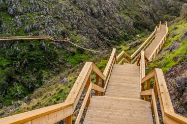 Beautiful wooden Boardwalk in the valley in Alferce, Algarve, south of Portugal clipart