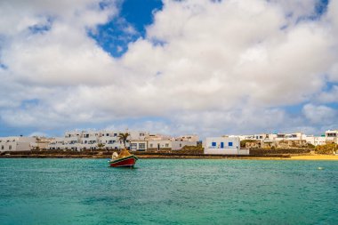 Beautiful coast of La Graciosa island with the boat in the foreground, Caleta del Sebo, one of Canary Islands, Spain clipart