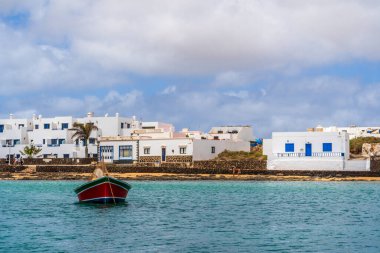 Beautiful coast of La Graciosa island with the boat in the foreground, Caleta del Sebo, one of Canary Islands, Spain clipart