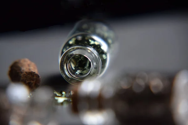 Stone Glass Wishing Bottle - Corked Miniature Bottle filled with metallic stones - Macro, Closeup of a Jar of Rocks