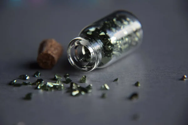 Stone Glass Wishing Bottle - Corked Miniature Bottle filled with metallic stones - Macro, Closeup of a Jar of Rocks