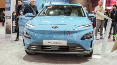 Crowds looking at new car models at Auto show. Hyundai Kona electric car on display. National Canadian Auto Show with many car brands. Toronto ON Canada Feb 19, 2023