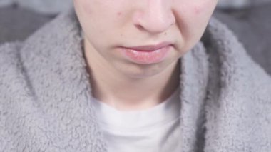 Closeup view 4k Young teenage kid smiles with metal brackets on teeth while playing on the phone. Orthodontic metal braces with transparent rubber band. Dental treatment for perfect bite.