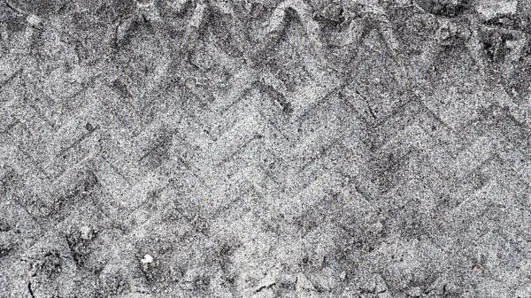 stock image Detailed black and white grunge texture with tire tracks, perfect for design backgrounds..