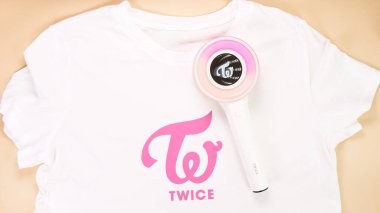 Gatineau, QC Canada - December 09 2024: Twice group DIY T-shirt with CandyBong light stick on yellow. South Korean girl group Twice clipart