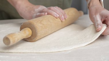 Eller, hamuru elle topa dönüştürüyor. Şef restoranda pizza ekmeği pişirmek için hamur hazırlıyor..