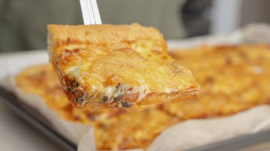 Tahta masa üzerinde servis edilen peynirli ve sosisli ev yapımı kare pizza tam peynirli organik pizza sağlıklı pizza..