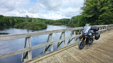Sargent 's Purchase, NH USA - 08.22.2024: Manzaralı Tahta Köprü Üzerinde Motosiklet Macerası
