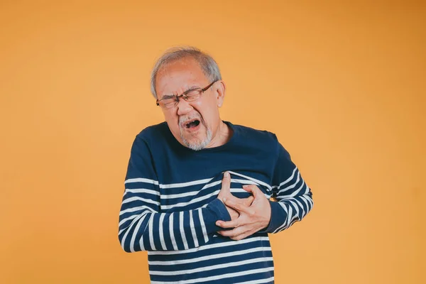 Senior male having chest pain his suffer from cardiac heart attack. Old elderly man patient has difficulty breath his chest. Healthcare insurance retirement concept