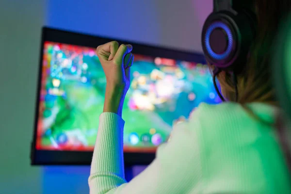 stock image Asian gamer playing online video game winning excited on PC with lighting effect, broadcast streaming live at home. Gamer and E-Sport online gaming technology Championship tournament gamer concept.