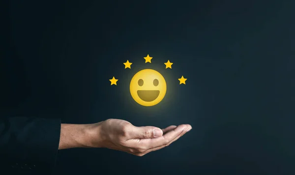 Hand giving positive emotion happy smile face and five star with copy space. Customer satisfaction feedback review concept.Customer service experience and business satisfaction