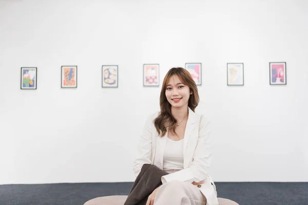 stock image Woman visiting art gallery her looking pictures on wall watching photo frame painting at artwork museum people lifestyle concept.