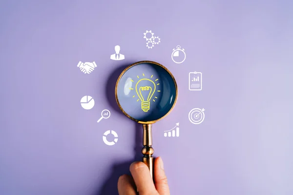 Magnifying glass focus to light bulb icon which for mind, creative, idea, innovation, motivation planning development leadership and customer target group concept.