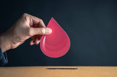 Kan bağışı kutusuna kesilmiş kan kağıtları, kan nakli, dünya kan bağışı günü, kan vermek için kızıl haç. Dünya hemofili günü konsepti.