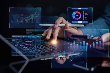 Analyst working with computer in Business Analytics and Data Management System to make report with KPI and metrics connected to database. Corporate strategy for finance, operations, sales, marketing.