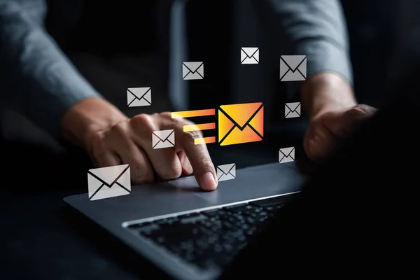 Businessman sending email by laptop computer to customer, business contact and communication, email icon, email marketing concept, send e-mail or newsletter, online working internet network.