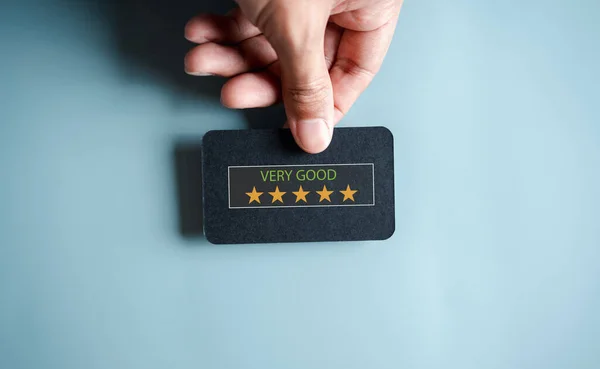 Customer Experiences giving five stars and smile face review, Client's Satisfaction Surveys on smartphone feedback review concept. Customer service experience and business satisfaction.
