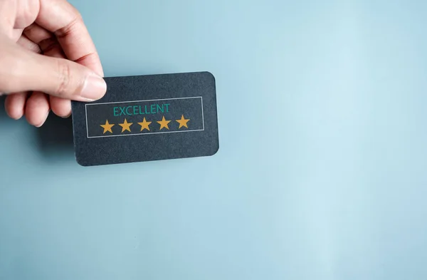 Customer Experiences giving five stars and smile face review, Client\'s Satisfaction Surveys on smartphone feedback review concept. Customer service experience and business satisfaction.