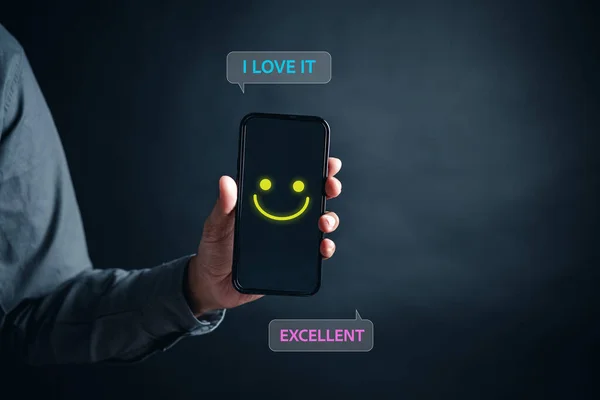 Customer Experiences of man give smile face, Client\'s Satisfaction Surveys on smartphone feedback review concept. Customer service experience and business satisfaction.