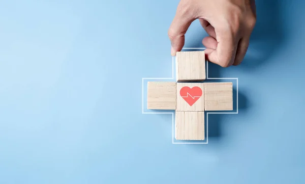 Health insurance concept. people hands putting plus symbol and healthcare medical wooden cube block with icon, health and access to welfare health concept
