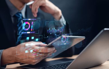Analyst working with computer in Business Analytics and Data Management System to make report with KPI and metrics connected to database. Corporate strategy for finance, operations, sales, marketing.