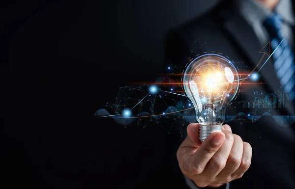 stock image Businessman holding light bulb for business analysis management, Idea and imagination, innovation development leadership, Solution analysis and development, Innovative technology.