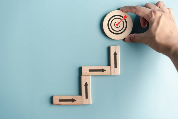 Business growth success achievement concept, hand arranging wooden block stacking as step stair or ladder or planning development leadership and customer target group
