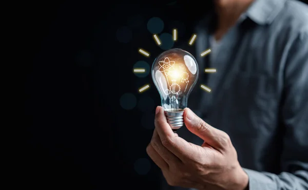 Man holding light bulb with learning education and graduation concept. study knowledge to creative thinking idea and problem solving solution, E-learning online education course degree certificate