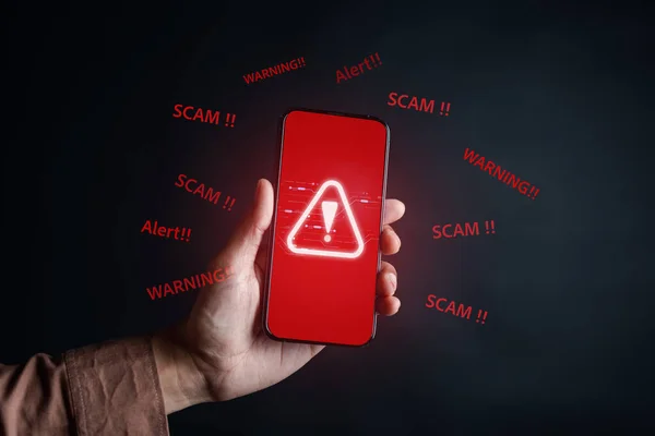 Scam alert on smartphone concept, virus hacker internet security, Businessman holding smart phone. Scam money from banking apps, Spam Email Pop-up Warning.
