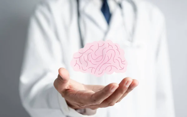 Doctor holding human brain icon, idea creative intelligence thinking or Awareness of Alzheimer, Parkinson\'s disease, dementia, stroke, seizure or mental health. Neurology and Psychology care.