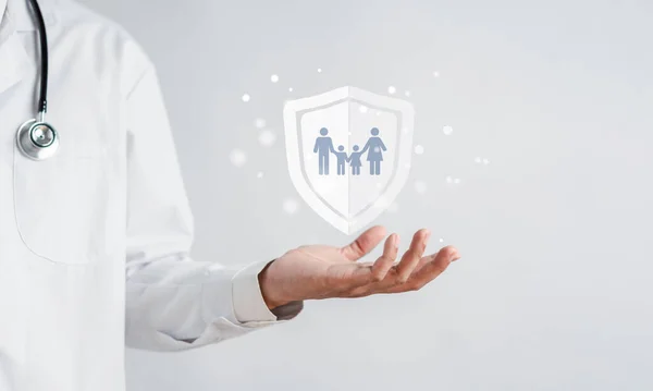 stock image Doctor in uniform with stethoscope hand protection family virtual icon.health care insurance and assurance concept .