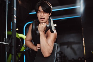 Erkek, spor salonunda halterli vücut geliştirici. Halterle egzersiz yapan vücut geliştirici. Spor eğitimi, sağlıklı vücut geliştirme, sporcu kaslı yaşam tarzı..