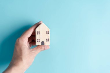Elde tutulan ahşap ev, aile evi, evsiz konutu, ipotek krizi ve ev koruma sigortası, uluslararası aileler günü, koruyucu aile bakımı, aile gündüz bakımı, evde kalma kavramı