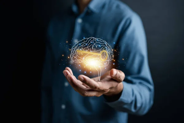 stock image Hand holding virtual human brain and golden key icon, idea creative intelligence to success business goal concept.