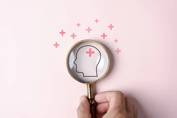 Stock image Magnifier focus to human brain icon and plus sign positive thinking concept, idea creative intelligence thinking or Awareness of Alzheimer, Parkinson's disease, dementia, stroke, mental health care.